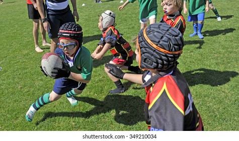 MILAN, ITALY-JUNE 02, 2013: children playing rugby in the park during a rugby school, in Milan.
