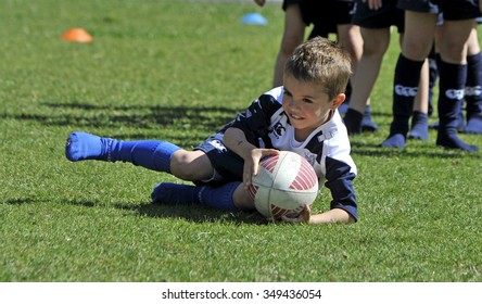 MILAN, ITALY-JUNE 02, 2013: children practicing during a rugby school session in the park, in Milan.