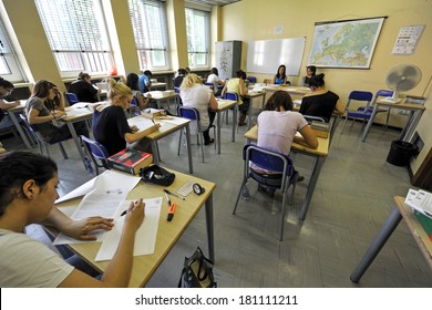 MILAN, ITALY-JUNE 20, 2012: College Students Seat On School Desk In The Exam Room, For The Secondary School's Final Exams, At The Artemisia Gentileschi School In Milan.