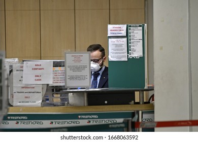 MILAN, ITALY-MARCH 08, 2020: Ticket Office Worker Wearing Anti Coronavirus Mask At The Central Train Station, In Milan.