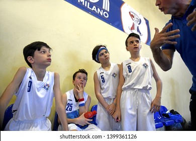 MILAN, ITALY-MARCH, 16, 2019: Kids Basketball Team Seat On The Bench, During Time-out, Of A Basketball Kids Final Competition, In Milan.