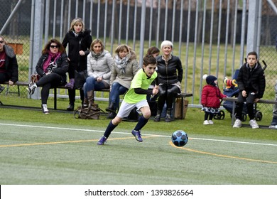 MILAN, ITALY-MARCH 17, 2019: parents watching and supporting during a kids soccer match, in Milan.