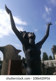 Milan, Italy-May 2018: A Woman Statue with Her Arms Towards the Sky in a Pray