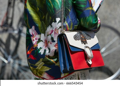 MILAN - JUNE 18: Woman With Blue, Red And White Gucci Bag And Silk Floral Shirt Before Salvatore Ferragamo Fashion Show, Milan Fashion Week Street Style On June 18, 2017 In Milan.