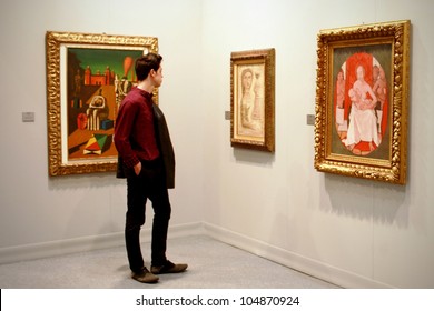 MILAN - MARCH 27: Man looks at paintings galleries during MiArt ArtNow, international exhibition of modern and contemporary art March 27, 2010 in Milan, Italy.