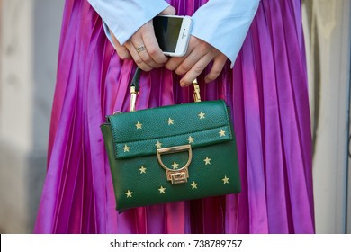 MILAN - SEPTEMBER 21: Woman With Green Coccinelle Leather Bag With Golden Stars And Fuchsia Metallic Skirt Before Fendi Fashion Show, Milan Fashion Week Street Style On September 21, 2017 In Milan.