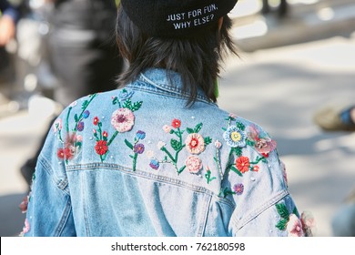 MILAN - SEPTEMBER 22: Woman With Blue Jeans Jacket With Floral Decorations Before Giorgio Armani Fashion Show, Milan Fashion Week Street Style On September 22, 2017 In Milan.