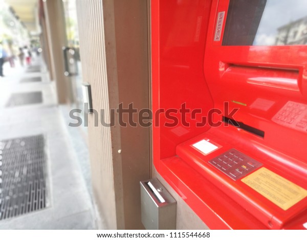 Milan,Italy-June 2018: Red ATM Automatic\
Teller Machine in the Street for Cash\
Withdrawal