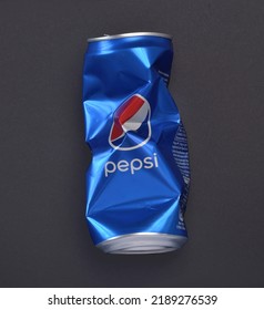 Milano, Italy - August 08, 2022: Wrinkled Pepsi Cola Can On Gray Background.. Pepsi Is A World Famous Carbonated Soft Drink,produced And Manufactured By Pepsico. The Beverage Was Created In 1893