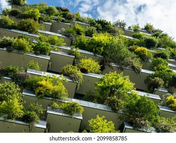 Milano, Italy. December 22, 2021. Bosco Verticale, a close up view at the modern and ecological skyscrapers with many trees on each balcony. Modern architecture, vertical gardens, terraces with plants