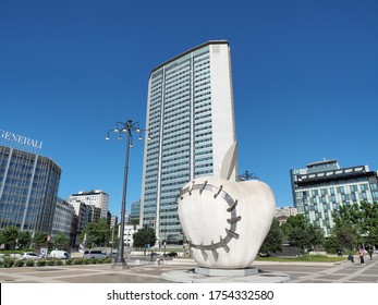 Milano, Italy. June 5, 2020. The Pirelli tower or called also Pirellone. It is the building where the Regional Council is based. A white big apple in the foreground made of steel and clay plaster