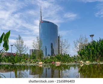 Milano, Italy. May 21, 2022. The iconic Unicredit tower and the BAM public park. In the foreground the pond with the water lilies in bloom