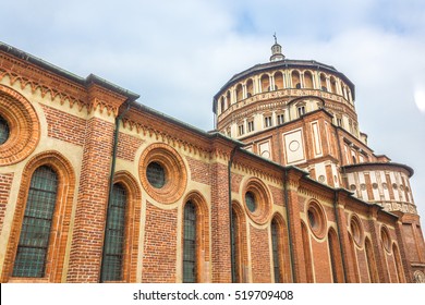 Milan's famous church Santa Maria Delle Grazie, hosting in it's refectory, The Last Supper mural painting by Leonardo da Vinci. side view with blue sky.