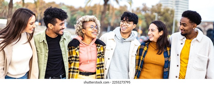 Milenial friends walking together in Barceloneta - Life style concept with happy guys and girls having fun around Barcelona city street - University students on travel vacations  - Bright vivid filter - Shutterstock ID 2255273795