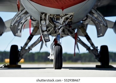 Military Aircraft Detail With Landing Gear And Engine Cover On A Runway