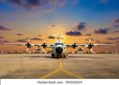 Military aircraft on the runway during sunset.