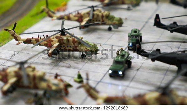 military airport with helicopters and trucks in\
miniature, army base