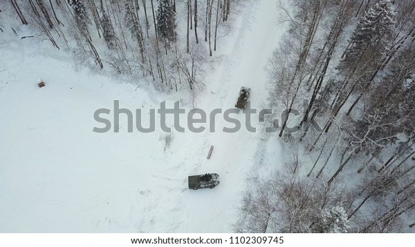 Military armored personnel carriers in the\
woods during military exercises. Clip. Top view of military armored\
personnel carriers in the forest in\
winter