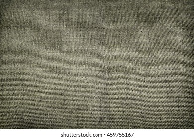 Military Army Coarse Canvas Fabric Cloth Tarp Tent Burlap Sack. Rough Grunge Texture Background Or Wallpaper Close Up. Toned Horizontal Image