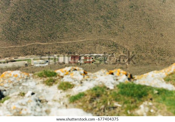 Military base in Bakhchisarai. Secret military\
base a top view. Military unit in Crimea, Russia. Tanks, armored\
personnel carriers,guns. War zone. Mountainous landscape. Military\
unit in the mountains