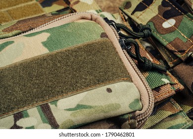 Military body armor on wooden background close up