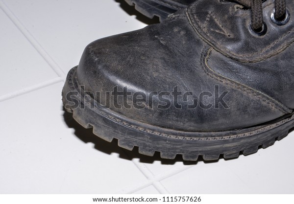 military boots black on the lock\
and with rivets, sole with a pattern, legs for protection of\
legs