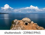 Military bunker (built during the Hoxhaist regime) in eastern Albania, standing on a rocky cliff overlooking wonderful blue Ohrid Lake