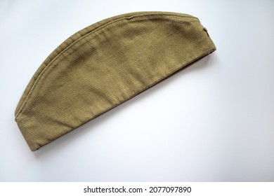 Military cap of a Soviet soldier on a white isolate. The headdress of the Soviet army. A green rag cap with a red star.