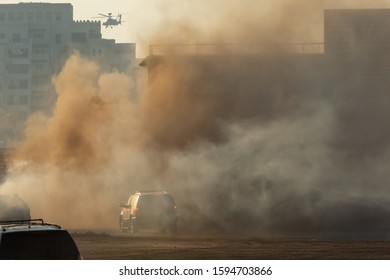 Military Chopper And Army Vehicles Flying And Driving Entering Into The Smoke And War . Military Concept Of Power, Force, Strength, Air Raid, Explosion.