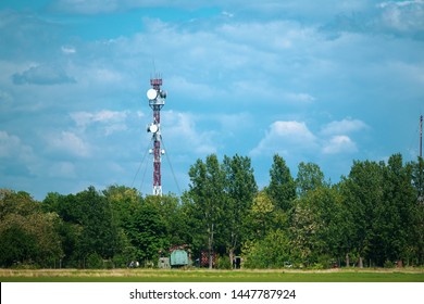 Military Communications Tower With Various Communication Equipments And Antennas For Radio And 5G Inside A Forest