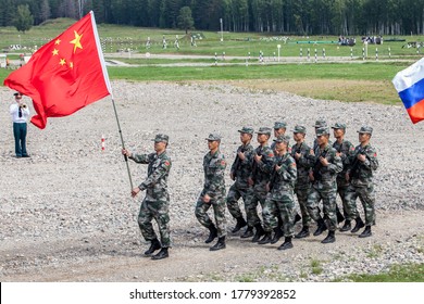 Military Competition ARMY 2018, A Platoon Of Soldiers Of The Chinese Army With The Flag Of The People's Republic Of China Marching In A Parade Step Kostroma Region The Town Of Pesochnoye June 2018