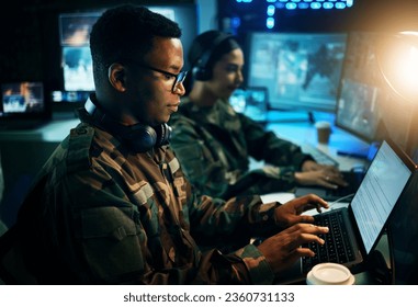 Military control room, computer and soldier at desk, typing code and tech for communication army office. Security, global surveillance and black man at laptop in government cyber data command center.
