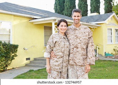 Military Couple In Uniform Standing Outside House