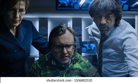 Military Dispatcher Wearing Headset Talks With Homeland Security Officials In The System Control / Monitoring Room. Joint Secret Operation Of Military And Government Intelligence.