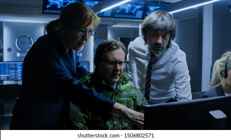 Military Dispatcher Wearing Headset Talks With Homeland Security Officials In The System Control / Monitoring Room. Joint Secret Operation Of Military And Government Intelligence.