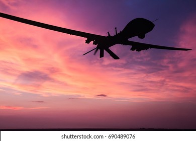 Military drone silhouette  on sunset background.