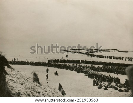 Military evacuation of Dunkirk during World War 2. Thousands of British and French troops wait on the dunes of Dunkirk beach for transport to England. May 26-June 4, 1940.