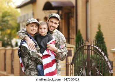 Military family reunited on a sunny day - Shutterstock ID 547550419