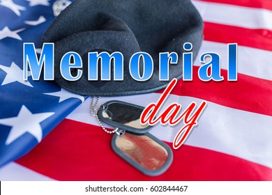military forces, patriotism and national holidays concept - memorial day words over american flag, soldiers badges and paratrooper hat
