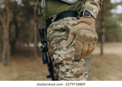 military hand. Camouflage tactical gloves. - Powered by Shutterstock