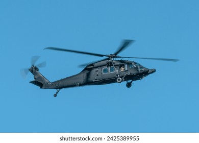 Military helicopter flying against the blue sky. Blackhawk helicopter - Powered by Shutterstock