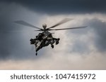 Military helicopter in the sky. Warplanes fly low pass at the evening sky