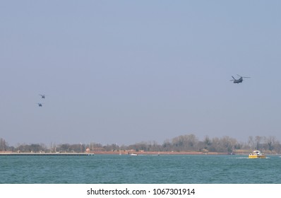 Military Helicopters in formation over the Venetian lagoon heading towards Aviano Air Base in Northeastern Italy.