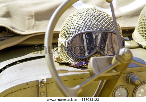 Military helmet lying on a\
off-road car