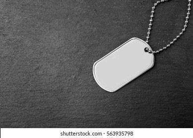 Military ID tag on dark background
