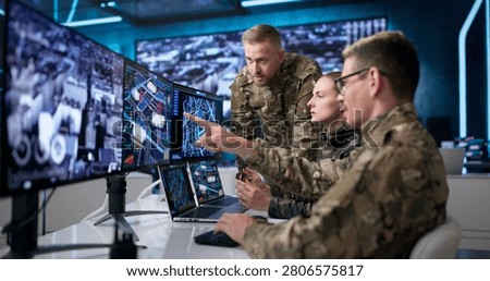 Military Intelligence Team Using Computers In Office To Monitor Missions.