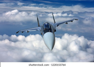 Military jet fighter aircraft flying on a high altitude over the clouds