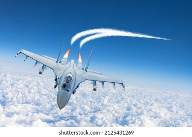 Military Jet Fighter Aircraft Flying On A High Altitude Over The Clouds, Leaving A Trail Of Condensation, Performing A Sharp Turn