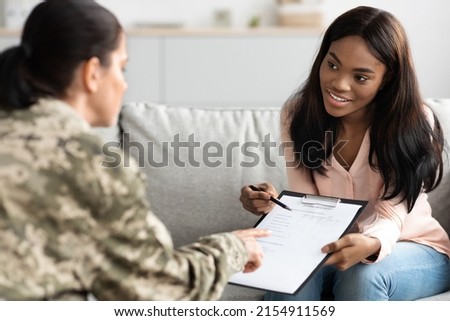Military Lady Filling Psychology Survey During Counselling Meeting With Psychologist, Smiling African American Psychiatrist Lady Holding Clipboard With Questionnaire, Asking Some Questions