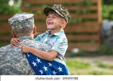 Military man father hugs son. Portrait of happy american family. focus on fathers back